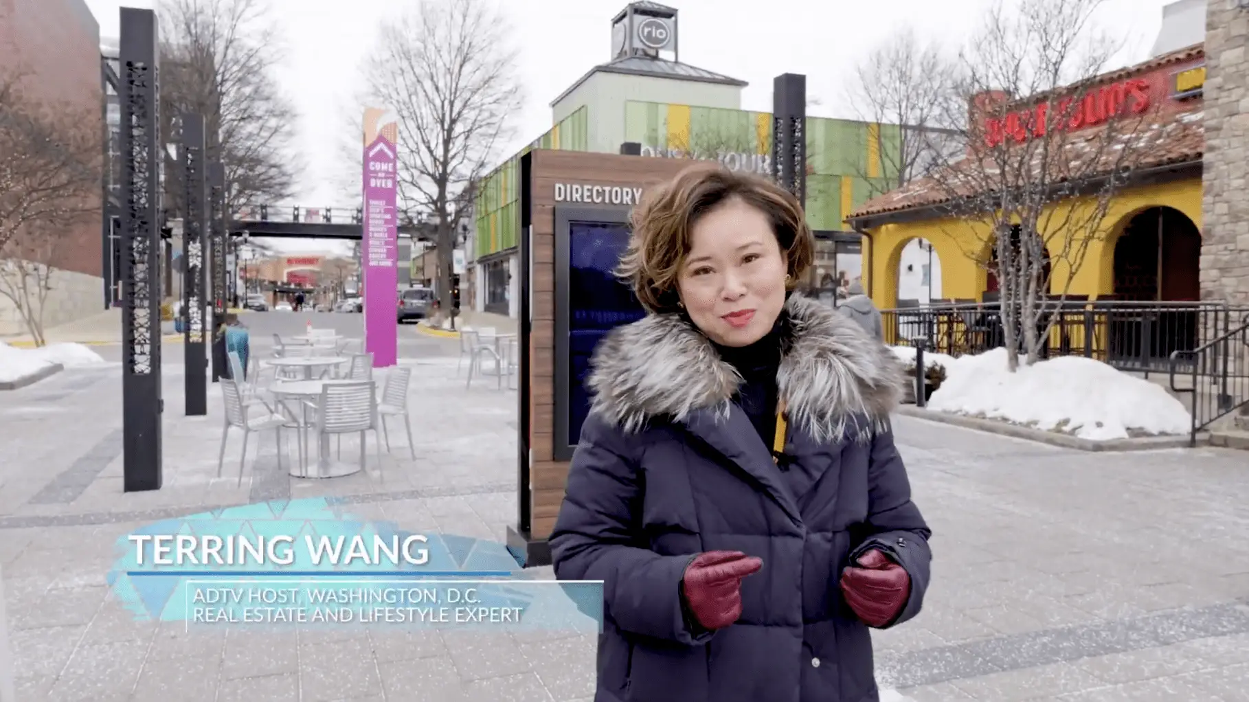 Person standing on snowy urban street.